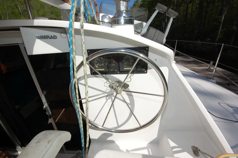 Slide: The Image of 1999 Wildcat 35 Catamaran steering wheel and control panel. - 25