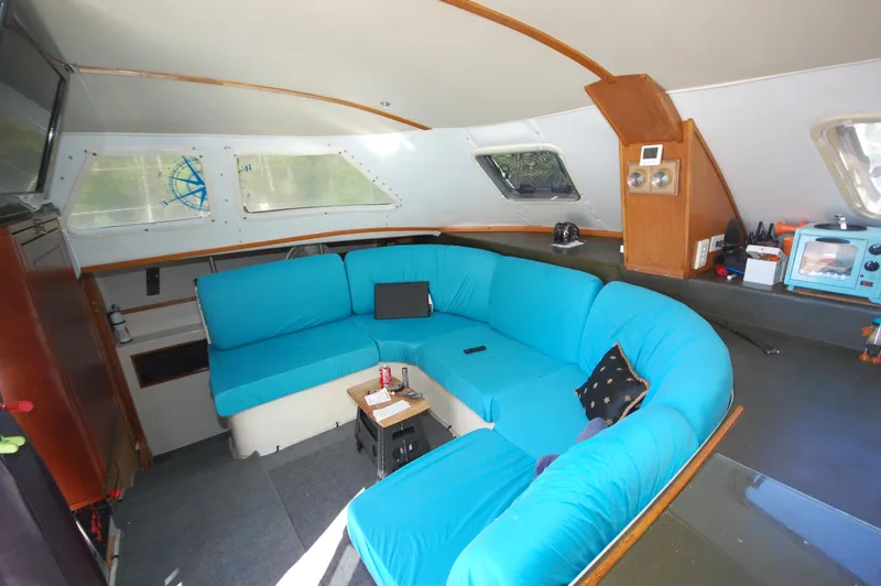Slide: The Image of Interior of 1999 Wildcat 35 Catamaran with blue seating and modern amenities. - 30
