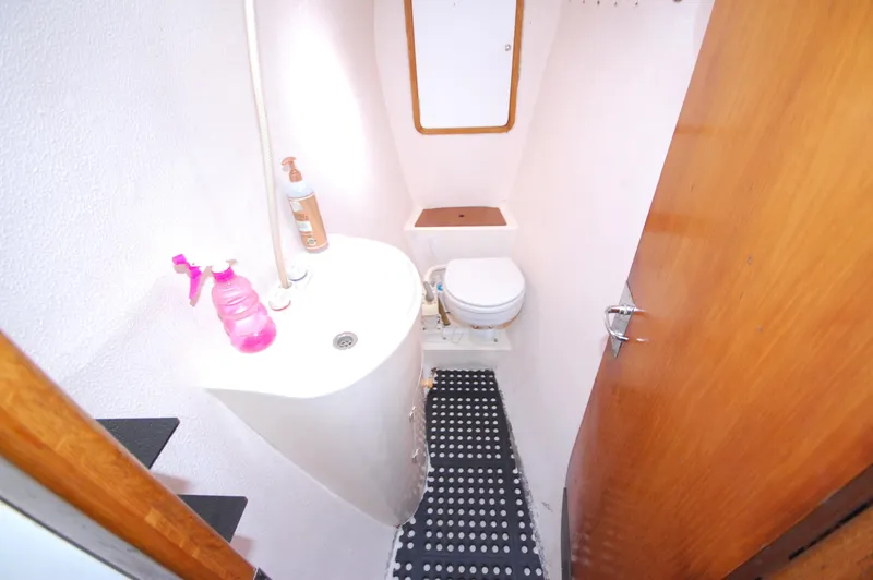 Slide: The Image of Compact bathroom in a 1999 Wildcat 35 Catamaran with sink and toilet. - 38