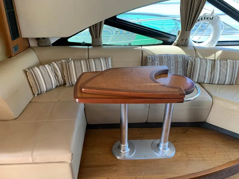 Slide: The Image of Luxurious interior of 2014 Sea Ray 510 Sundancer with beige leather seating and wooden table. - 10