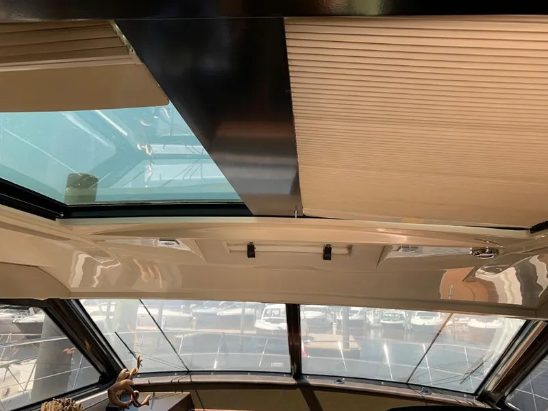 Slide: The Image of Interior view of 2014 Sea Ray 510 Sundancer with sunroof and large windows. - 11