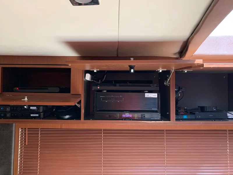 Slide: The Image of Open cabinet with electronic equipment on a 2014 Sea Ray 510 Sundancer yacht. - 13