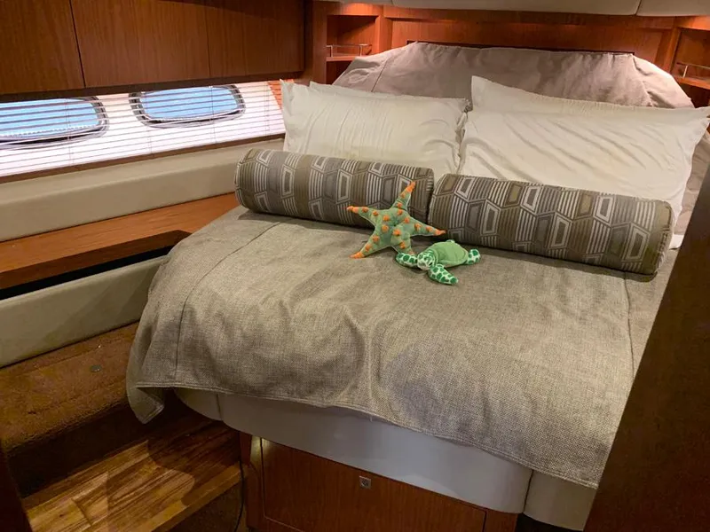 Slide: The Image of Luxurious bedroom interior of 2014 Sea Ray 510 Sundancer yacht with plush bedding. - 16