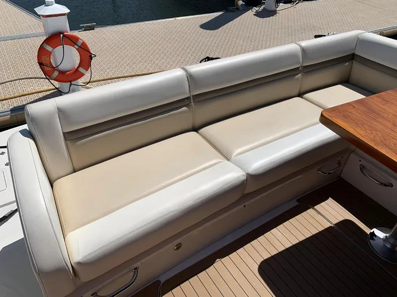 Slide: The Image of 2014 Sea Ray 510 Sundancer yacht with beige leather seating and wooden table. - 17