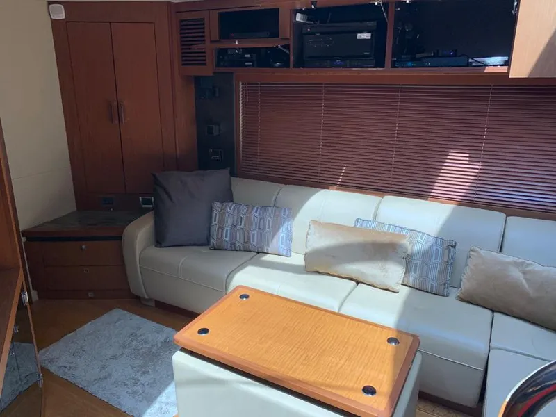 Slide: The Image of Interior of 2014 Sea Ray 510 Sundancer with white leather sofa and wooden accents. - 20