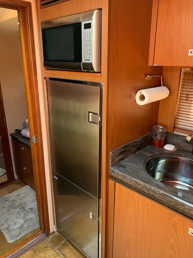 Slide: The Image of Modern kitchen area in 2014 Sea Ray 510 Sundancer yacht with stainless steel appliances. - 27