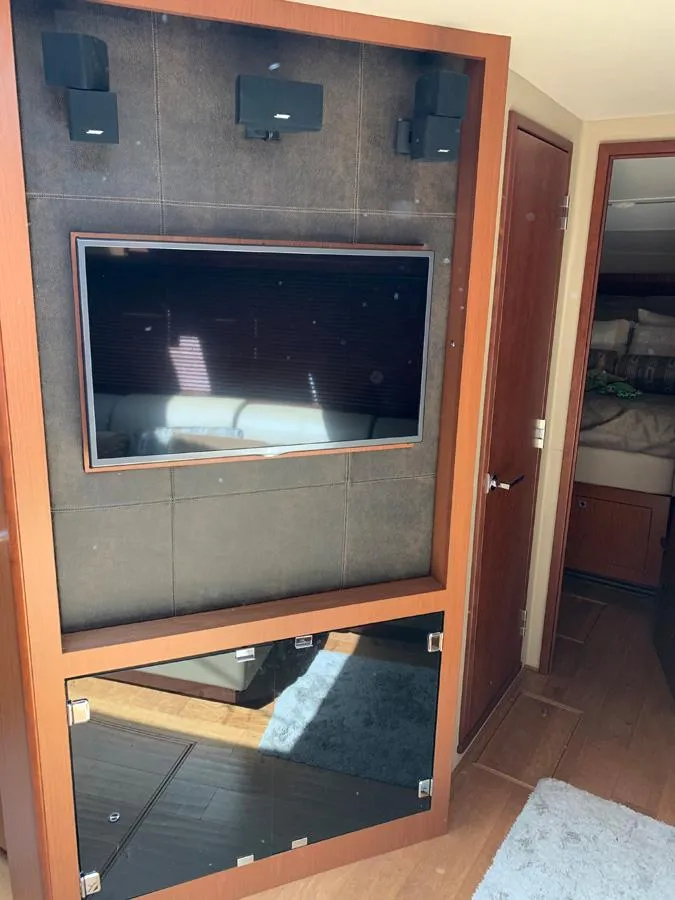 Slide: The Image of Entertainment center in 2014 Sea Ray 510 Sundancer yacht with mounted TV and speakers. - 34