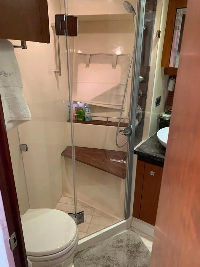 Slide: The Image of 2014 Sea Ray 510 Sundancer bathroom with shower, toilet, and sink. - 38