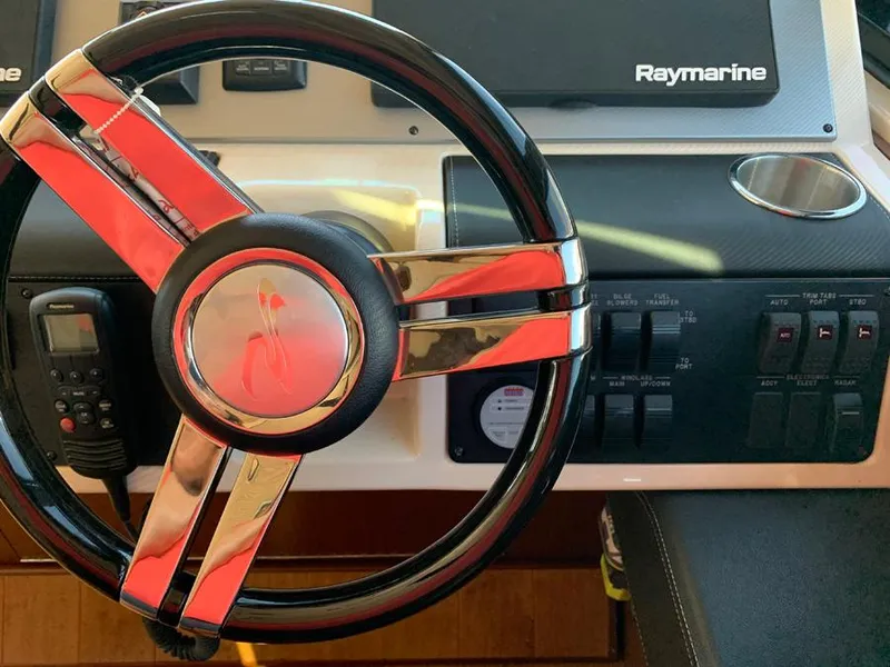 Slide: The Image of Steering wheel and control panel of a 2014 Sea Ray 510 Sundancer yacht. - 4