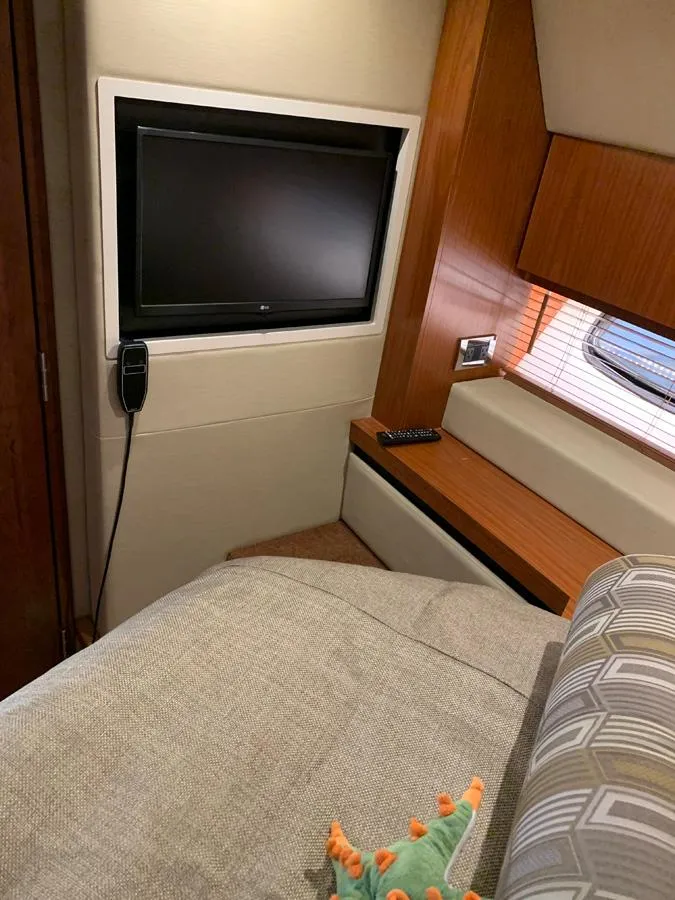 Slide: The Image of Interior of 2014 Sea Ray 510 Sundancer with TV and bed. - 40