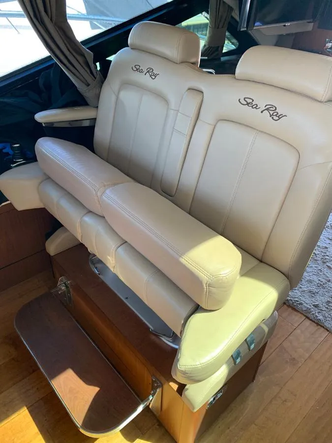 Slide: The Image of 2014 Sea Ray 510 Sundancer beige leather captain's chair with footrest. - 7