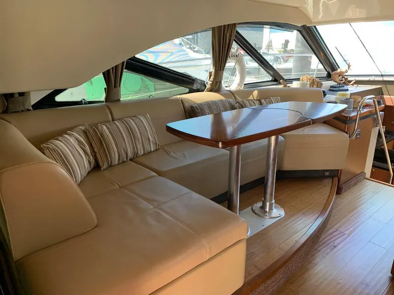 Slide: The Image of Luxurious interior of 2014 Sea Ray 510 Sundancer yacht with leather seating and wooden table. - 9