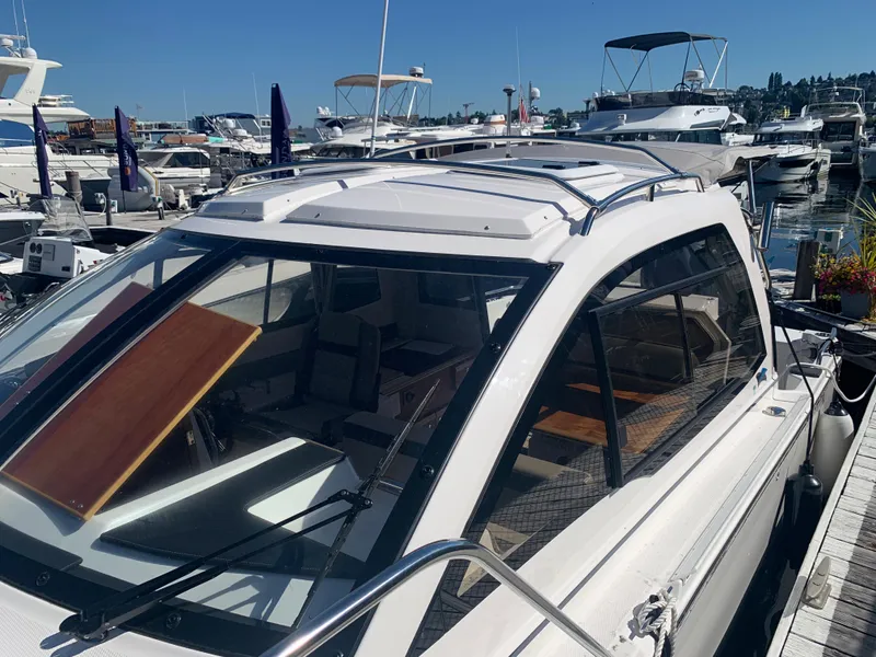 Slide: The Image of 2022 Cutwater C-24 Coupe docked at a marina under clear blue skies. - 13