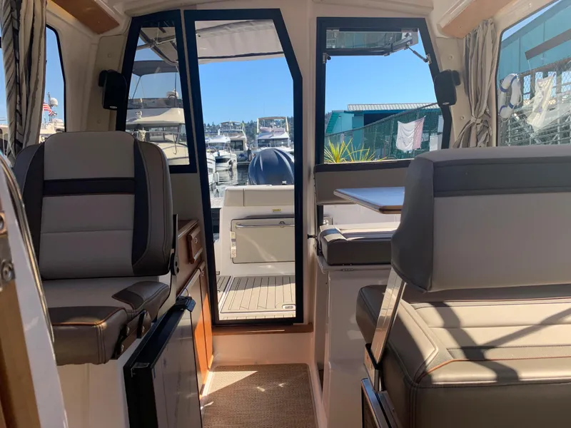 Slide: The Image of Interior view of 2022 Cutwater C-24 Coupe boat with seating and outdoor access. - 19