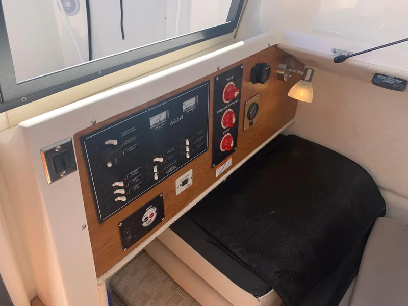 Slide: The Image of Control panel inside 2022 Cutwater C-24 Coupe boat, featuring switches and dials. - 21
