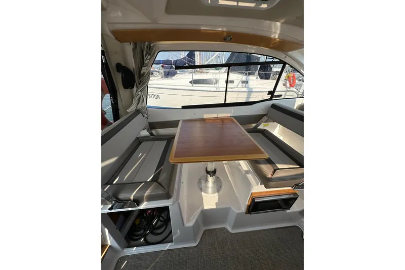 Slide: The Image of Interior of 2022 Cutwater C-24 Coupe with seating and wooden table. - 23