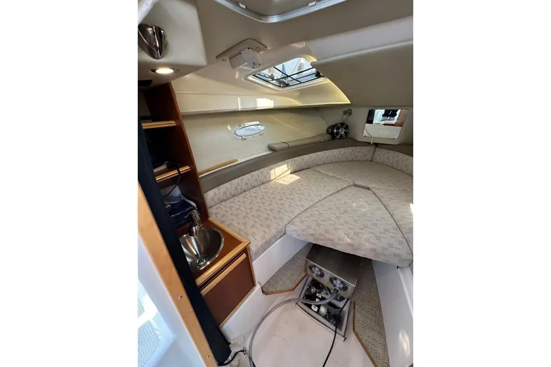 Slide: The Image of Interior of 2022 Cutwater C-24 Coupe, featuring cozy cabin and compact kitchenette. - 25