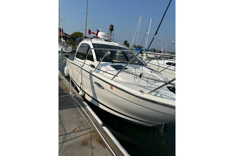 Slide: The Image of 2022 Cutwater C-24 Coupe docked at a marina, showcasing sleek design and modern features. - 3