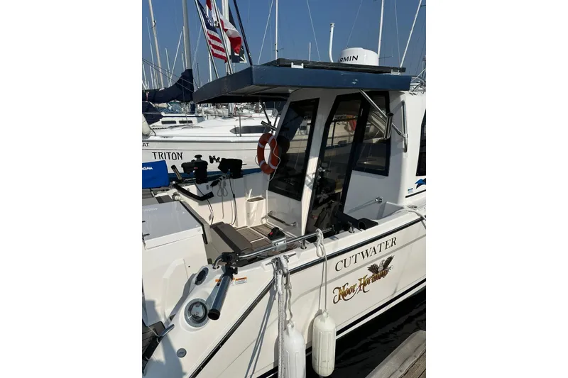 Slide: The Image of 2022 Cutwater C-24 Coupe docked, featuring sleek design and modern amenities. - 4