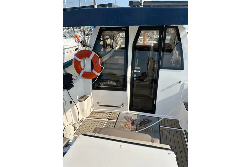 Slide: The Image of 2022 Cutwater C-24 Coupe boat with life preserver and teak deck. - 5