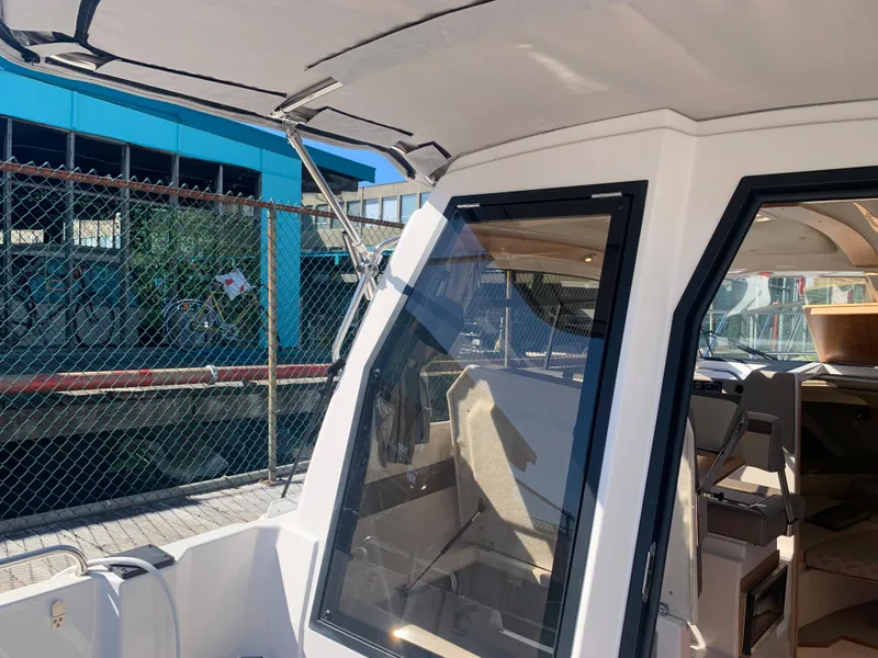 Slide: The Image of 2022 Cutwater C-24 Coupe boat docked, showcasing sleek design and spacious interior. - 9