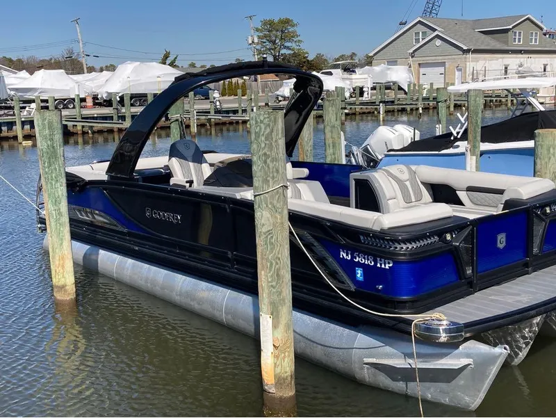 Slide: The Image of 2020 Godfrey San Pan 26 pontoon boat docked at a marina. - 10