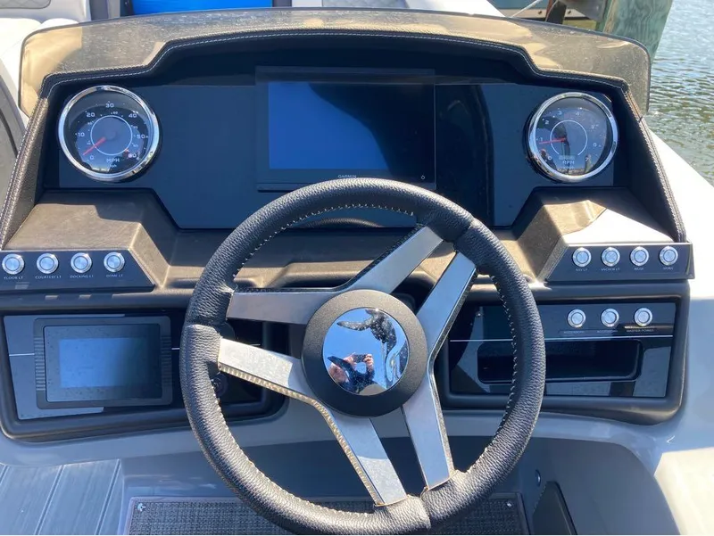 Slide: The Image of Dashboard of a 2020 Godfrey San Pan 26 boat with steering wheel and gauges. - 11