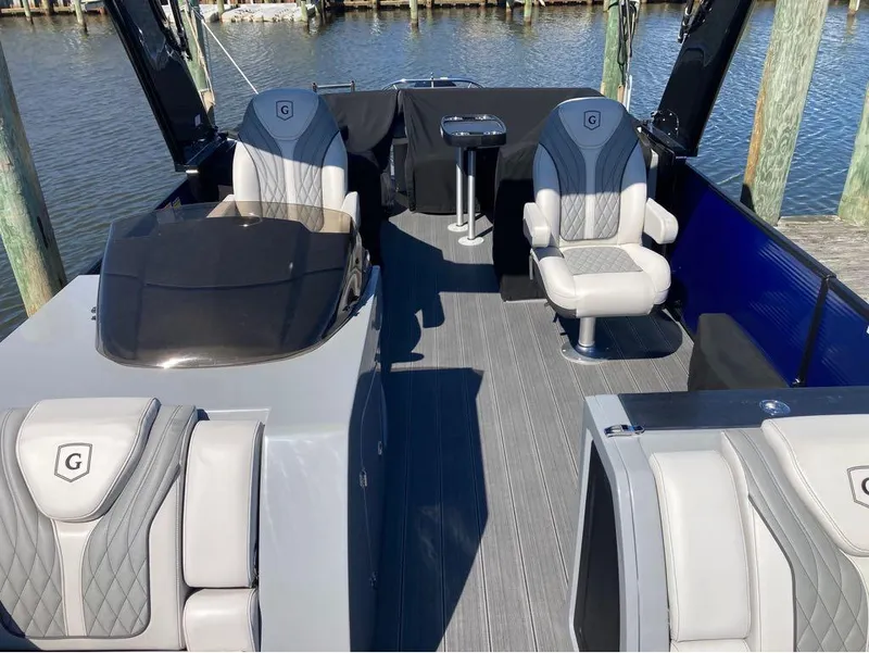 Slide: The Image of 2020 Godfrey San Pan 26 boat interior with luxury seating and helm station. - 13