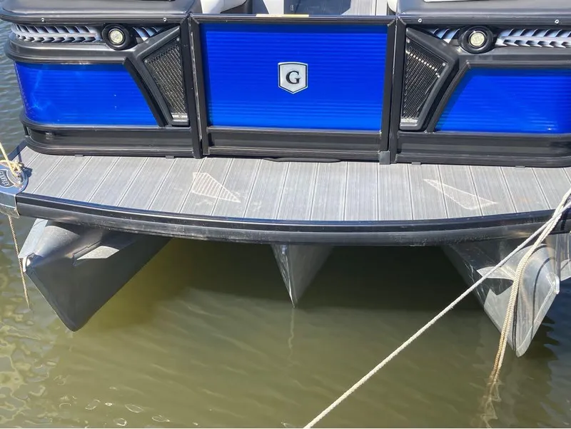 Slide: The Image of 2020 Godfrey San Pan 26 pontoon boat docked, rear view. - 16