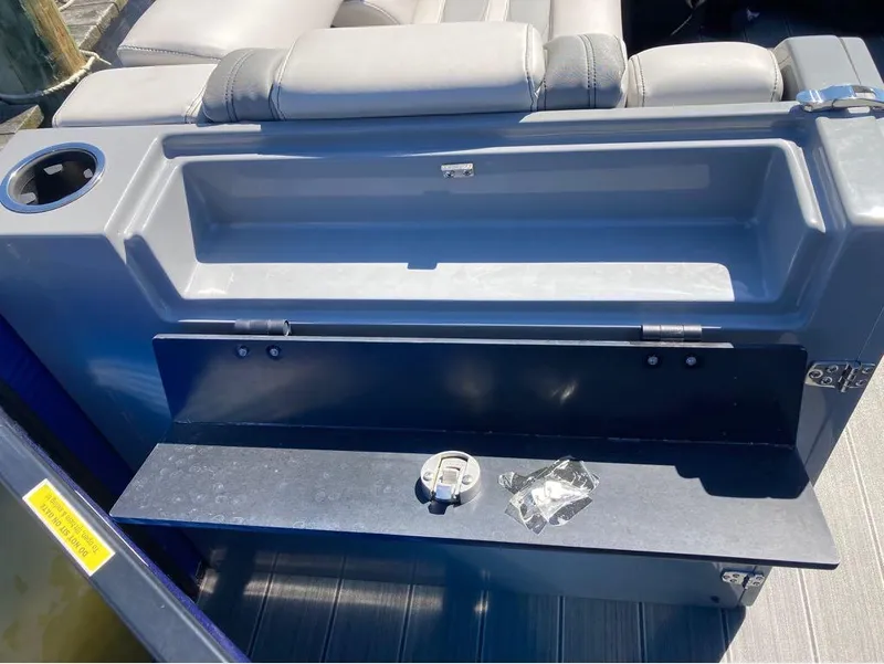 Slide: The Image of Godfrey San Pan 26 2020 boat storage compartment with cup holder and seating. - 18