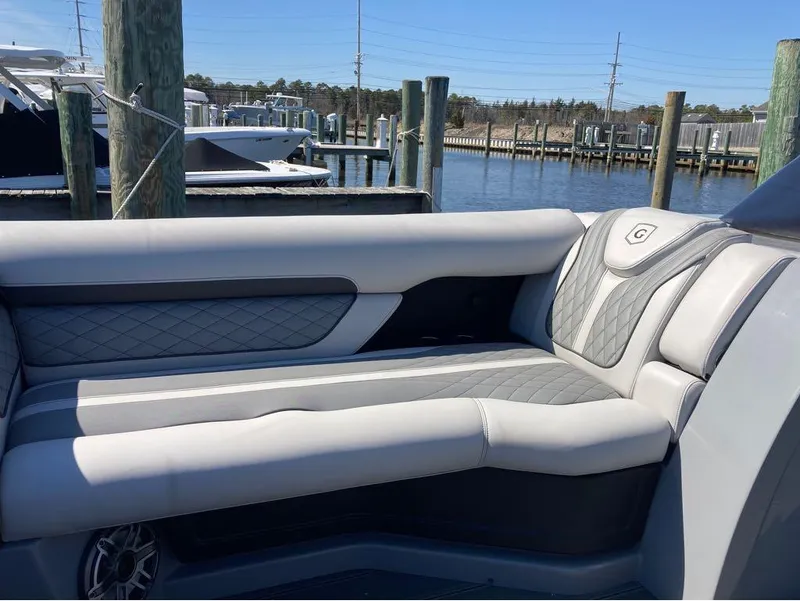 Slide: The Image of Luxurious seating on a 2020 Godfrey San Pan 26 pontoon boat docked at a marina. - 19