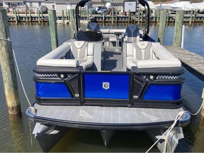 Slide: The Image of 2020 Godfrey San Pan 26 pontoon boat docked at a marina. - 6