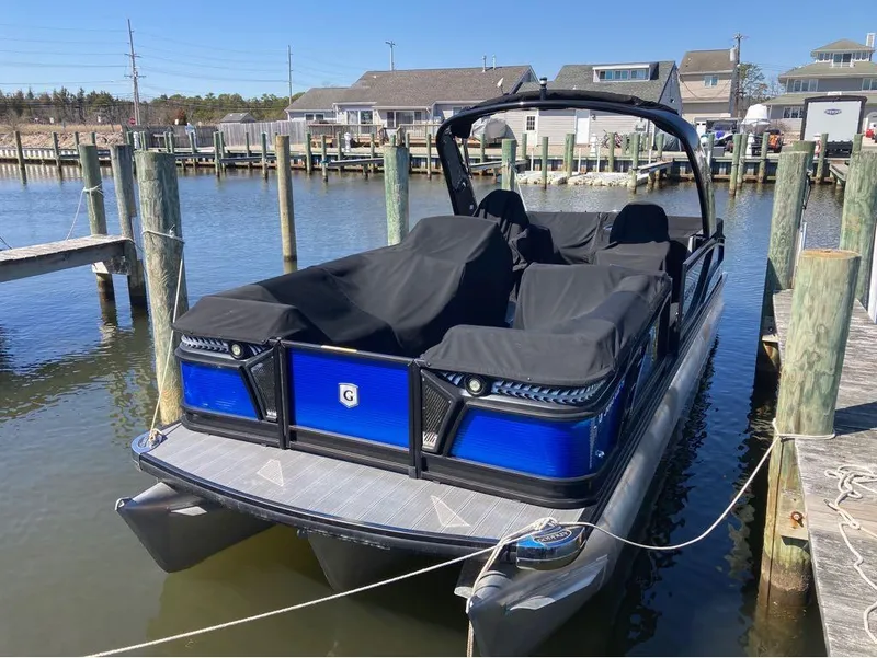 Slide: The Image of 2020 Godfrey San Pan 26 pontoon boat docked at a marina. - 8