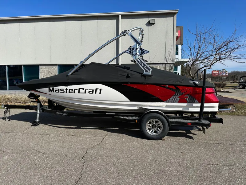 Slide: The Image of 2011 MasterCraft X2 boat on trailer in front of building. - 15