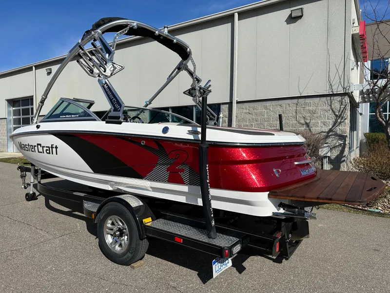 Slide: The Image of 2011 MasterCraft X2 boat on trailer in front of building. - 3