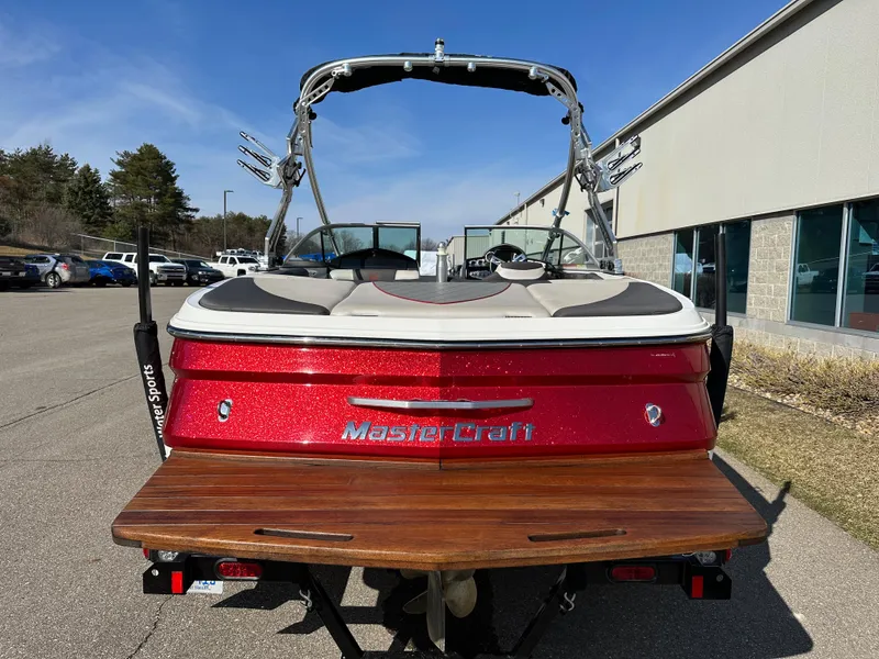 Slide: The Image of Red 2011 MasterCraft X2 boat in parking lot, rear view. - 5