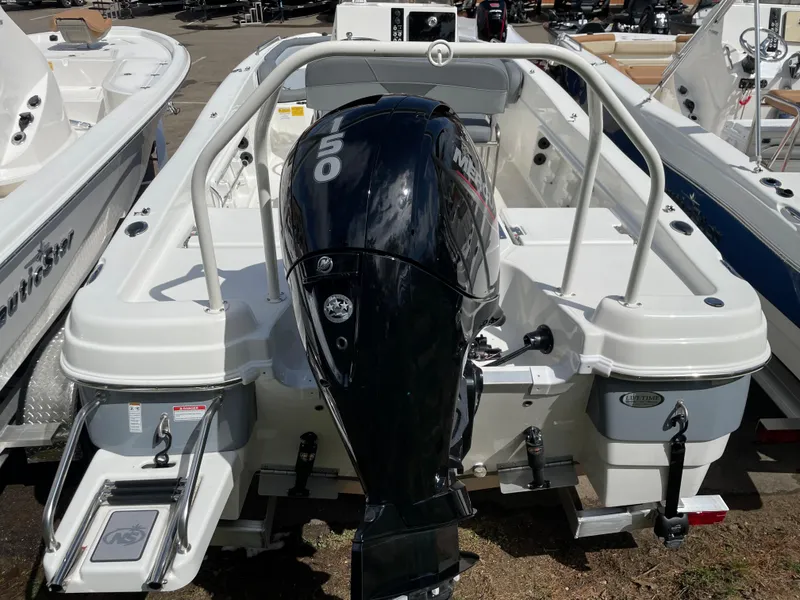Slide: The Image of 2023 NauticStar 211 Hybrid boat with outboard motor, rear view. - 2