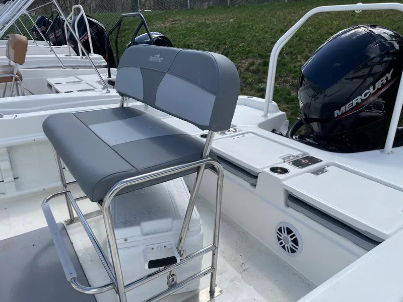 Slide: The Image of 2023 NauticStar 211 Hybrid boat with Mercury outboard engine and cushioned seating. - 4