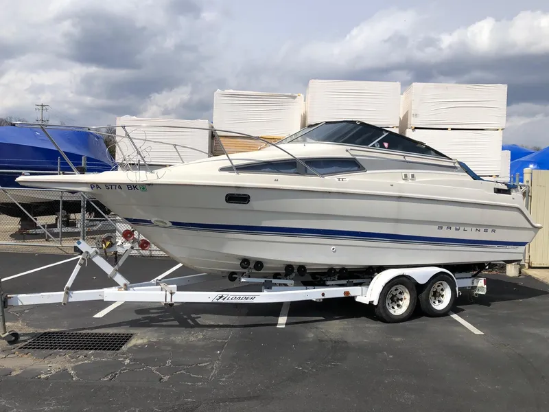 The Image of 1994 Bayliner 2655 Cierra boat on a trailer in a parking lot. - 0