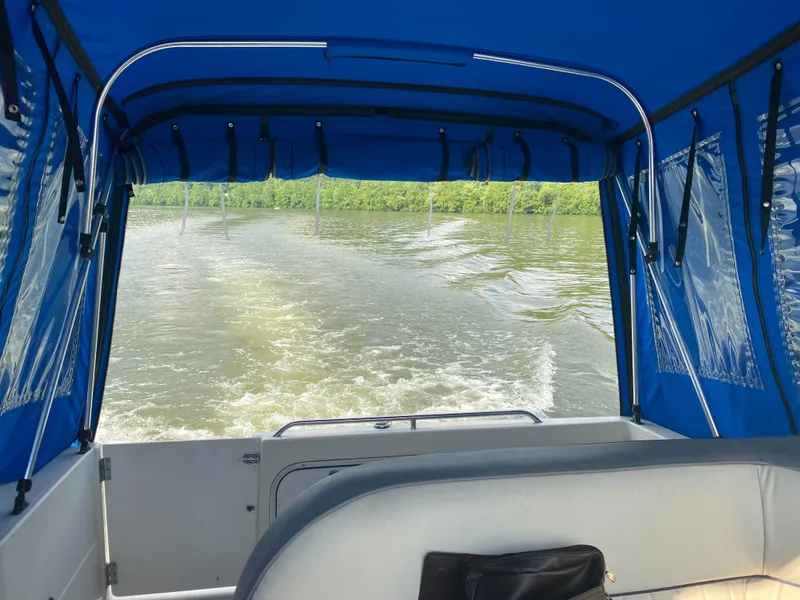 Slide: The Image of View from inside a 1994 Bayliner 2655 Cierra boat with blue canopy. - 17