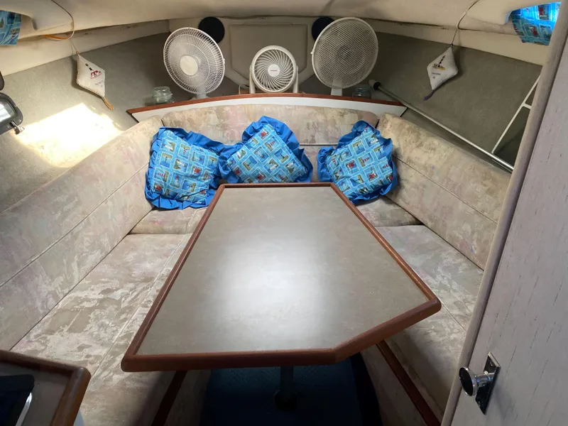 Slide: The Image of 1994 Bayliner 2655 Cierra cabin interior with table, seating, and fans. - 21