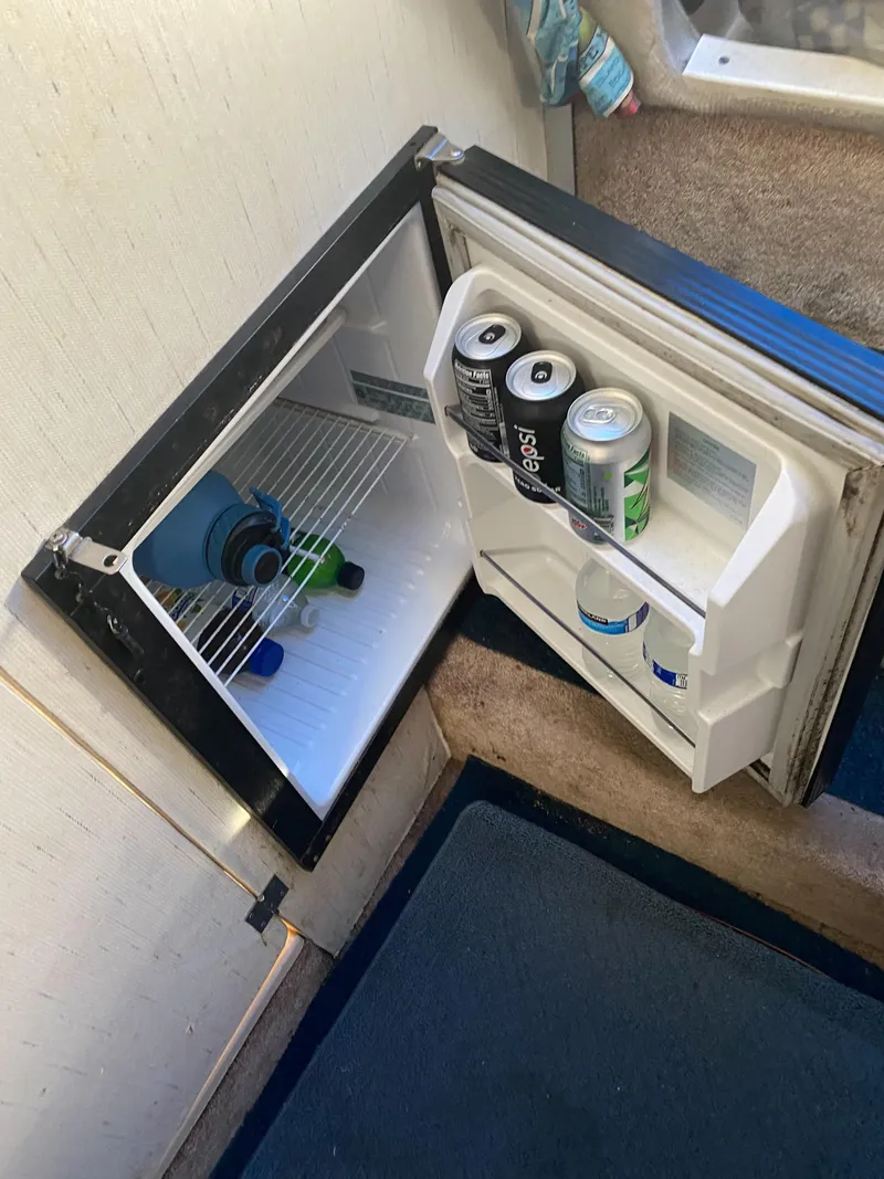 Slide: The Image of Mini fridge inside 1994 Bayliner 2655 Cierra boat, stocked with drinks. - 22