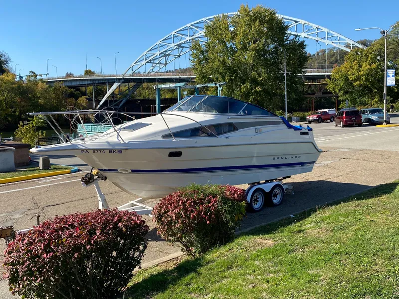 Slide: The Image of 1994 Bayliner 2655 Cierra boat on trailer near bridge and greenery. - 3