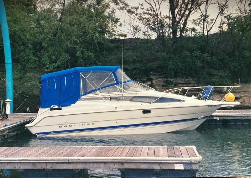 Slide: The Image of 1994 Bayliner 2655 Cierra boat docked with blue canopy. - 6