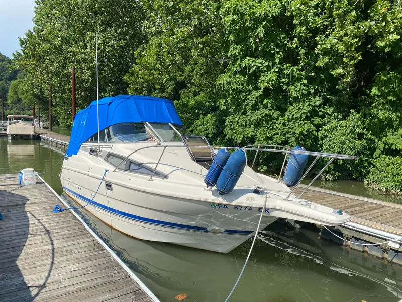 Slide: The Image of 1994 Bayliner 2655 Cierra boat docked with blue canopy and fenders. - 7