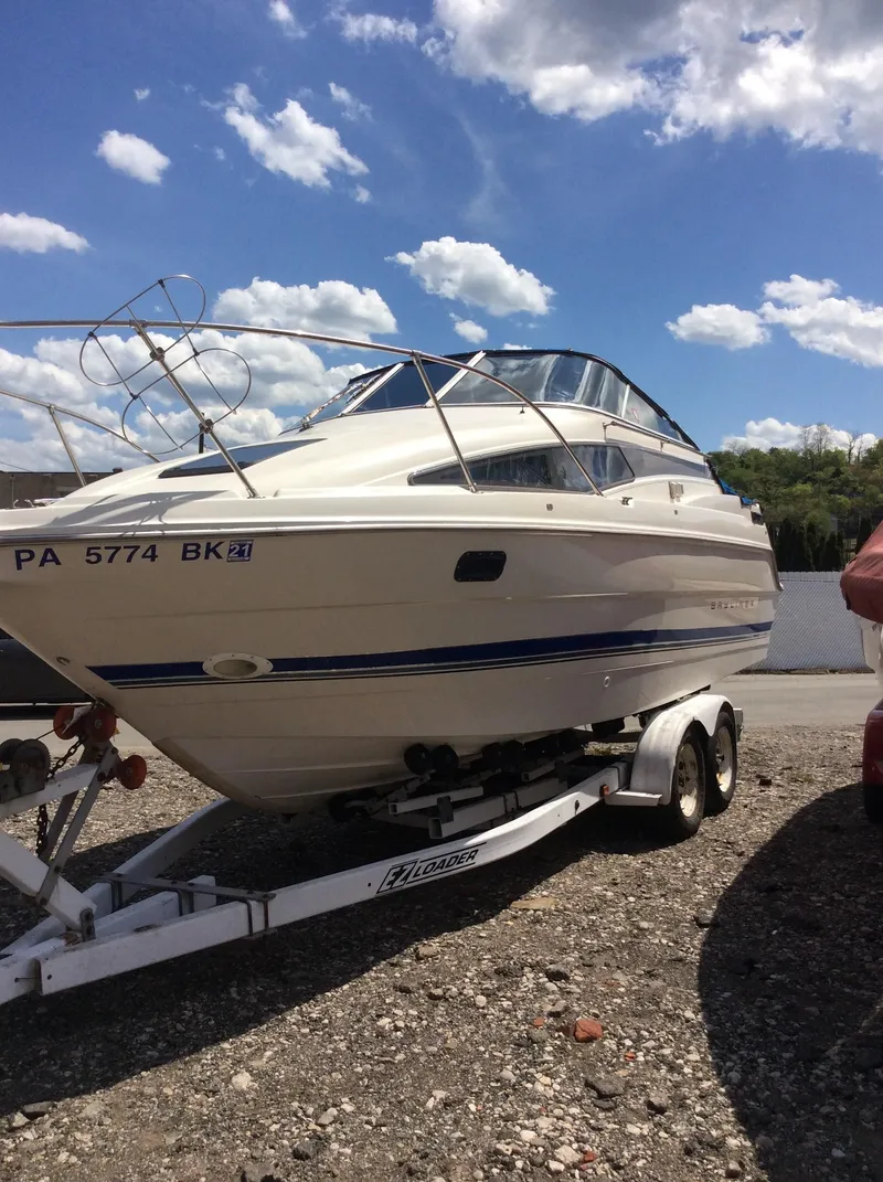 Slide: The Image of 1994 Bayliner 2655 Cierra boat on a trailer under a blue sky. - 9