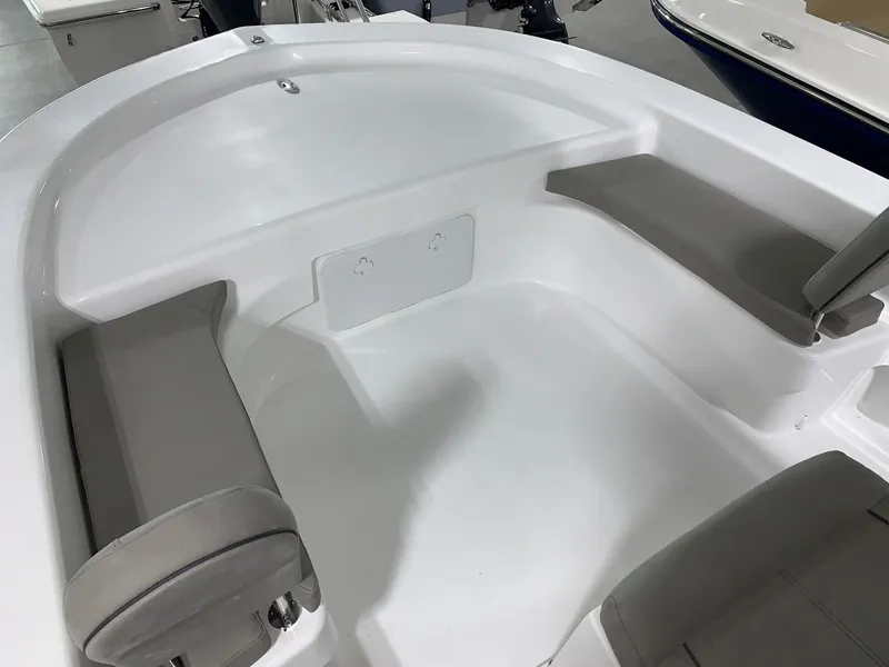 Slide: The Image of 2024 Savannah SS21 boat interior with cushioned seating and white deck. - 12