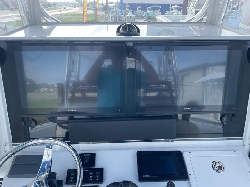 Slide: The Image of 2019 Freeman 37 boat dashboard with dual Garmin screens and steering wheel. - 16