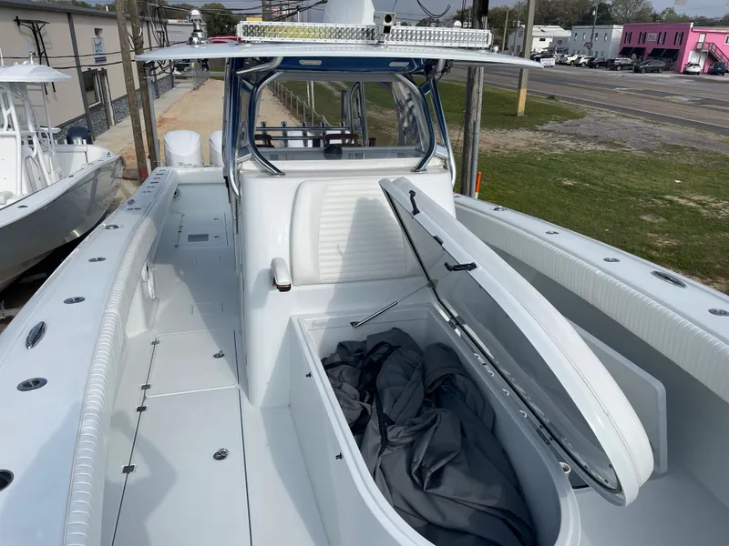 Slide: The Image of 2019 Freeman 37 boat with open storage compartment on deck, docked near a road. - 18