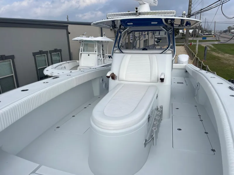 Slide: The Image of 2019 Freeman 37 boat with spacious deck and seating, docked outdoors. - 24